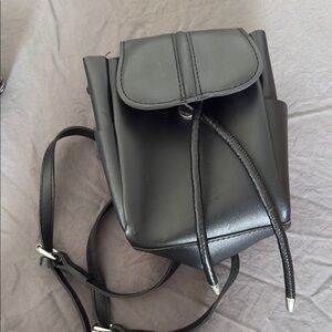 Stylish Black Backpack with Flap Closure and Adjustable Straps